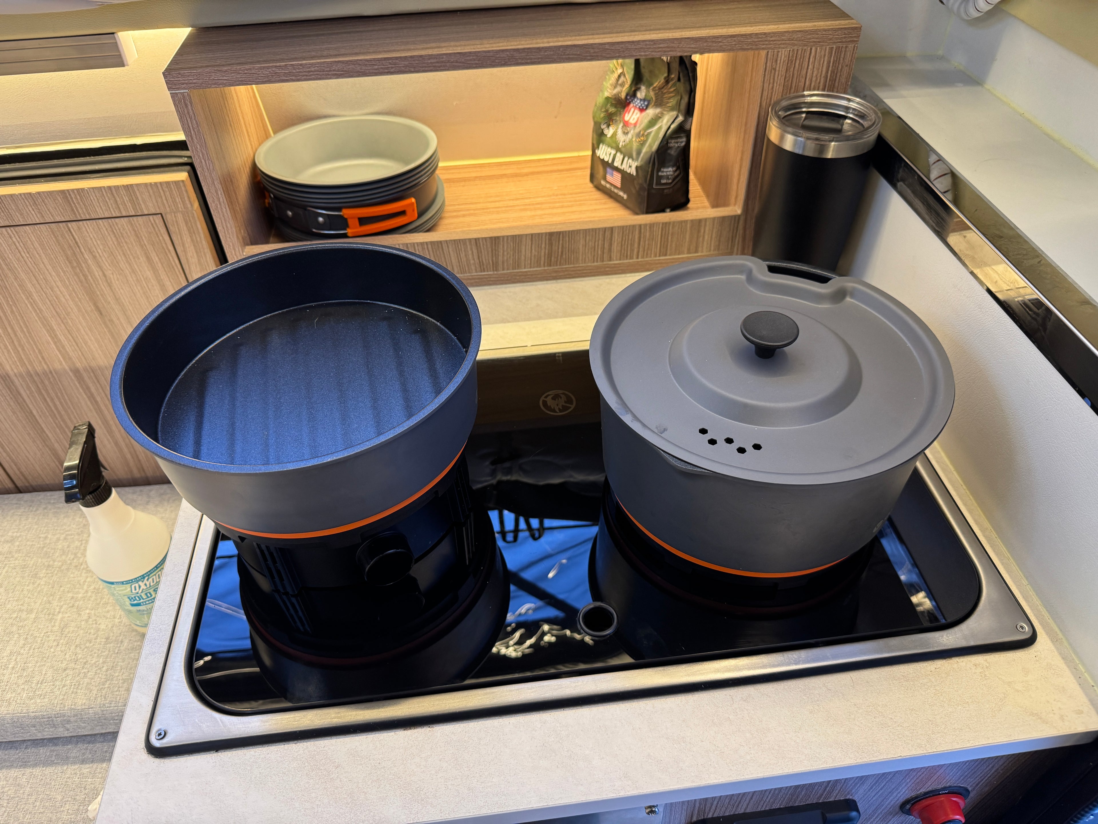 Cooking pots on a stove top with a kitchen setting in the background
