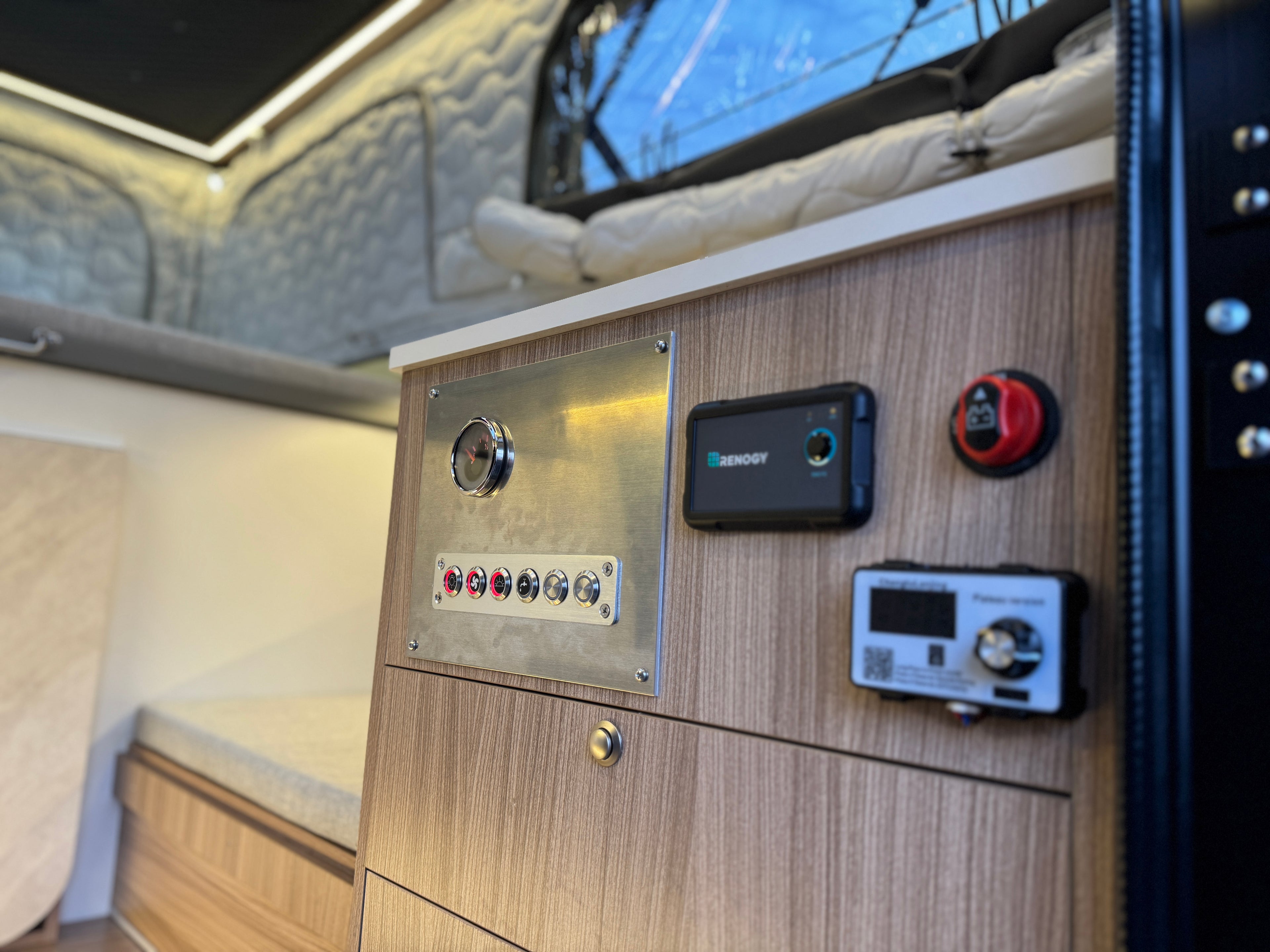 Control panel with buttons and displays inside a vehicle or RV.