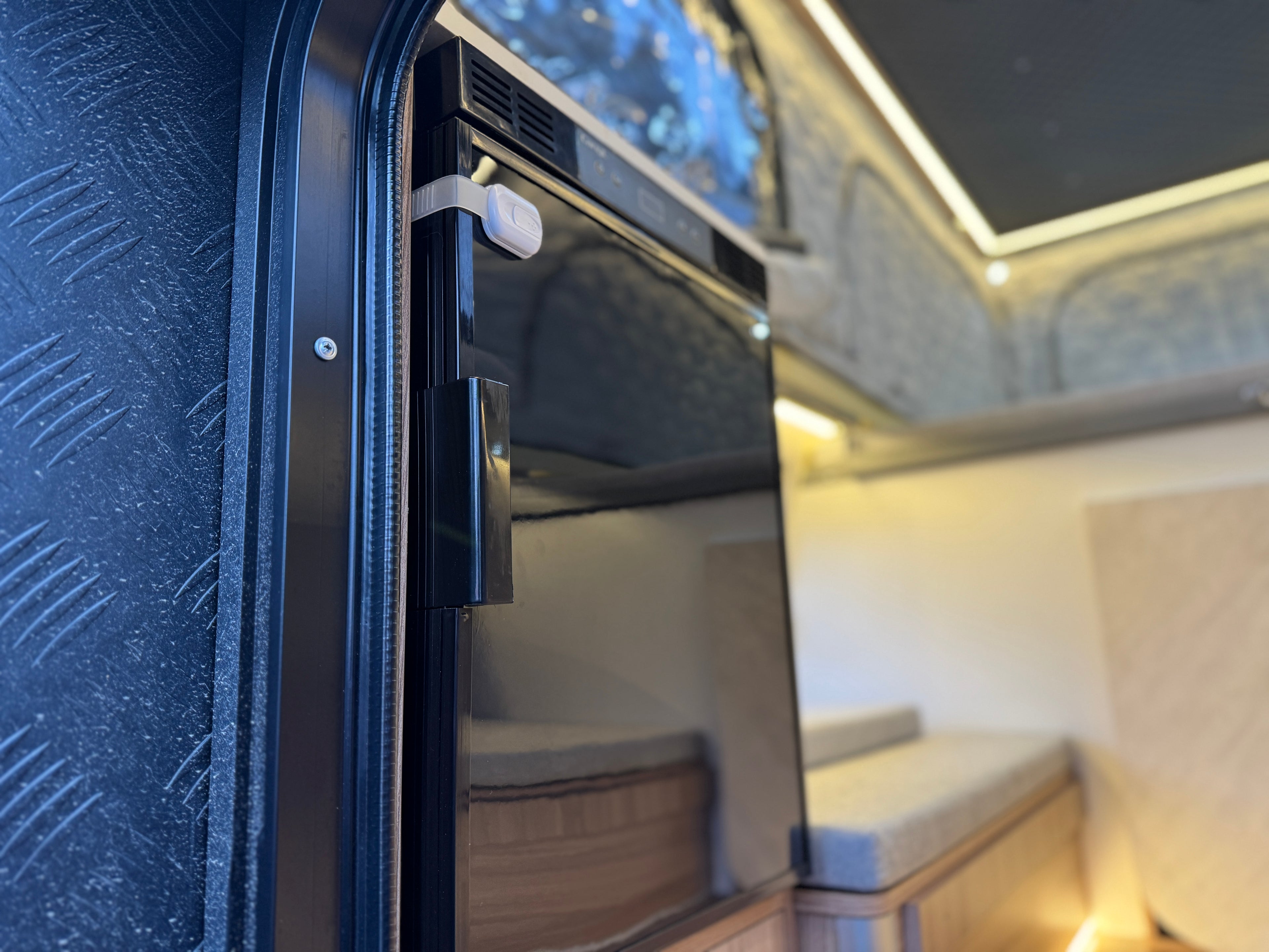 Close-up of a vehicle interior with an open door, showing the seating area.