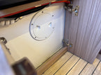 Close-up of a boat's interior with a circular hatch cover.