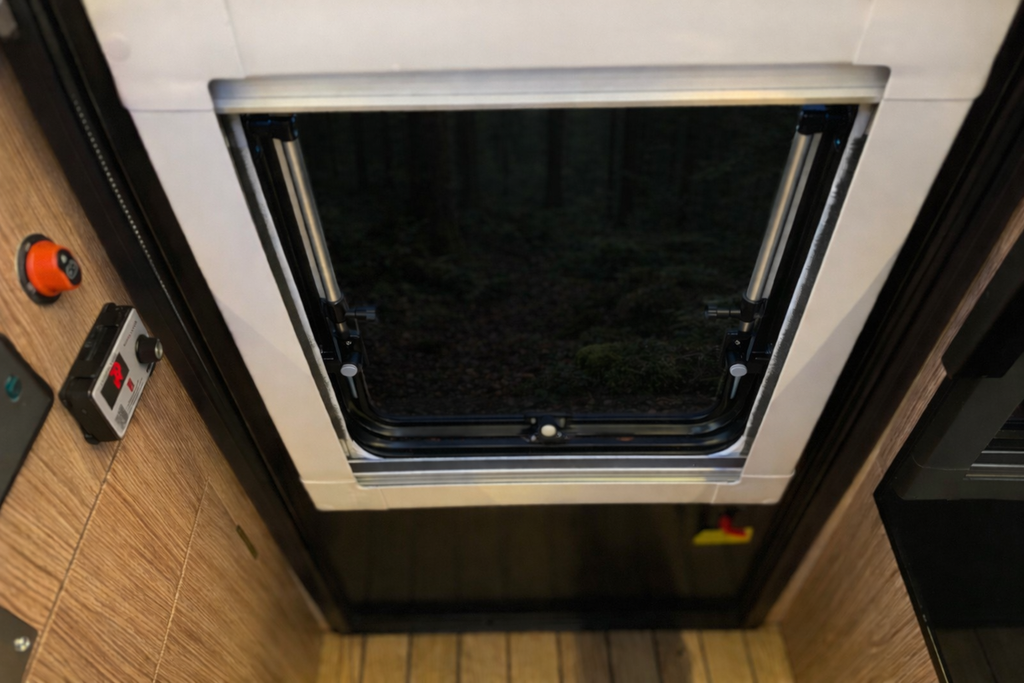 Small refrigerator with a black interior in a compact kitchen setting