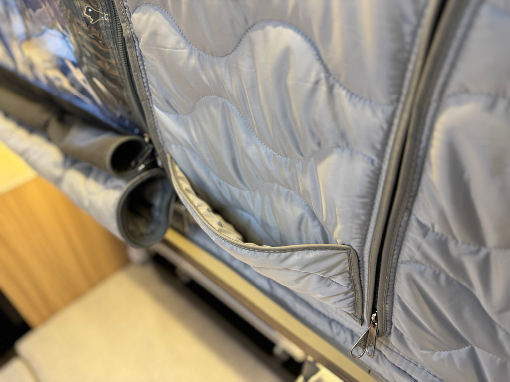 Close-up of a quilted jacket with a zipper, showing the texture and design.