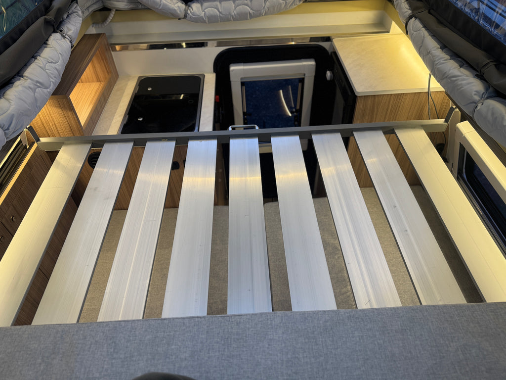 Bed with striped bedding in a compact living space